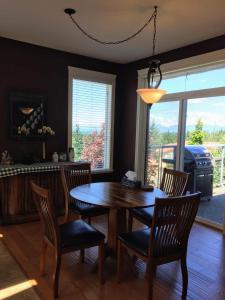 a dining room with a table and chairs and a grill at NeckPoint Treasure BnB in Nanaimo
