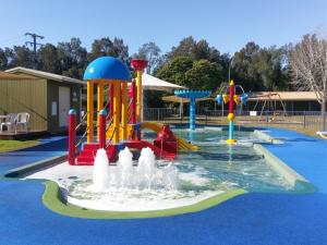 a swimming pool filled with lots of colorful toys at Tuncurry Lakes Resort in Tuncurry