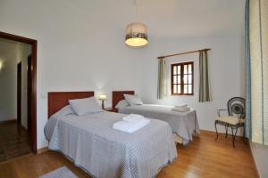 a hotel room with two beds and a window at Horta Nova in Lagos +37 photos