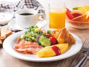 a plate of breakfast food with a cup of coffee at APA Hotel & Resort Yokohama Bay Tower in Yokohama