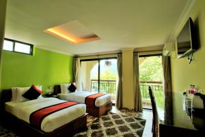 Letto o letti in una camera di Hotel Raniban Arcade