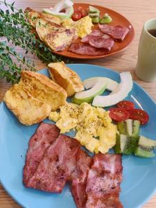 琉球茶室 現代館 في شياوليوكيو: طبق أزرق من طعام الإفطار مع اللحوم والخضروات