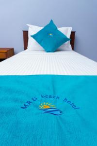 A bed or beds in a room at MRD Beach Hotel