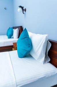 A bed or beds in a room at MRD Beach Hotel
