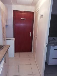 a bathroom with a brown door and a toilet at Agréable Studio Lumineux in Aix-les-Bains