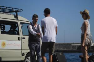 a group of three men standing next to a van at Hotel Il Girasole in Anacapri
