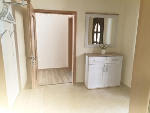 an empty room with a mirror and a white cabinet at Ferienwohnung Sandra in Heilbad Heiligenstadt