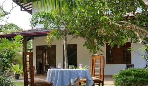 a table and chairs in front of a house at Dream House in Hikkaduwa