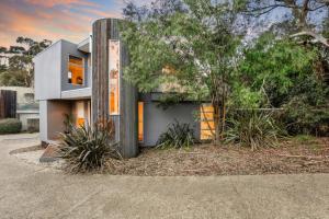 a modern house with a tree in front of it at Seascape - The Ultimate Inverloch Retreat in Inverloch