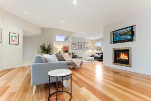 a living room with a couch and a fireplace at Seascape - The Ultimate Inverloch Retreat in Inverloch