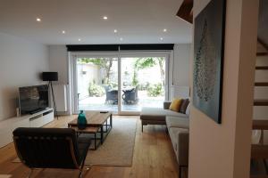 a living room with a couch and a table at House Forelle Gent in Ghent