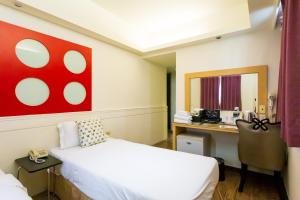 Postel nebo postele na pokoji v ubytování Newrise Hotel