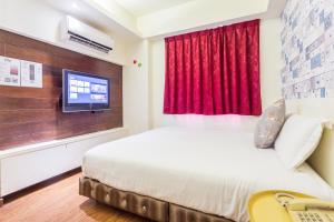 Postel nebo postele na pokoji v ubytování Newrise Hotel