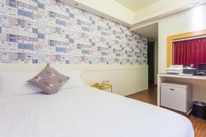 Postel nebo postele na pokoji v ubytování Newrise Hotel