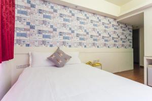 Postel nebo postele na pokoji v ubytování Newrise Hotel