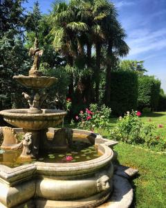 a fountain with a statue in a garden at Torre de Salis in Gussago