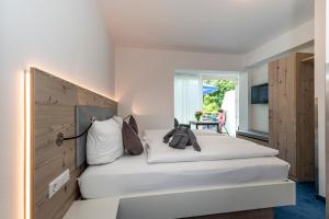 a bedroom with a large white bed with a headboard at Gästehaus Holzer in Konstanz