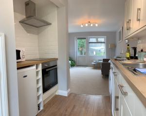 a kitchen with white cabinets and a counter top at 5 Harbour Lights in Penzance