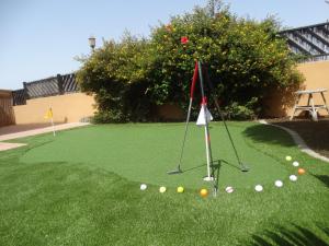 a golf course with balls on the grass at Villadunas - with luxury hot tub in Corralejo