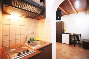 a kitchen with a sink and a stove top oven at Pension Ioanna in Adamantas