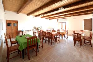 a dining room with tables and chairs in a building at Agriturismo Laire Masseria in Alberobello