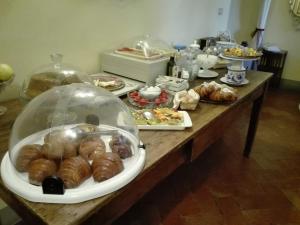 a table with a bunch of pastries and other foods at Villa Aurora di Ferracciano in Borgo San Lorenzo