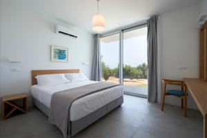 Rúm í herbergi á Kalypso Residence