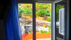 una finestra aperta con vista su un cortile di Apartments Zunic a Trogir