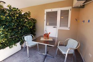 a table and two chairs on a patio at Apartments Baron in Sveti Stefan