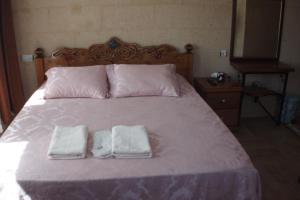 A bed or beds in a room at Emre's Stone House