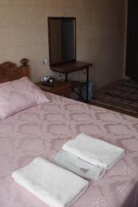 A bed or beds in a room at Emre's Stone House