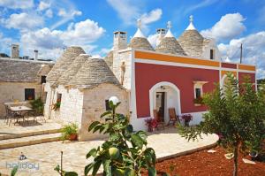 een huis met rieten daken en een patio bij I Trulli Di Nonno Giovanni in Martina Franca