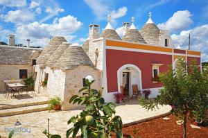 a house with thatched roofs with a patio at I Trulli Di Nonno Giovanni in Martina Franca