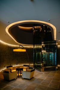 a lobby of a building with chairs and a table at Townhouse Dresden in Dresden
