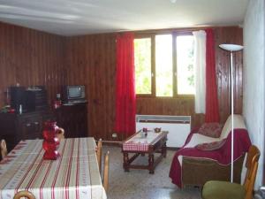 a living room with a table and a couch and a room with a tableablish at Rdc Chalet in Pra-Loup