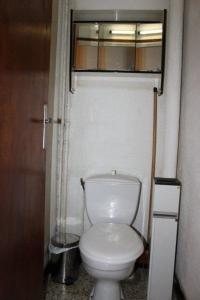 a bathroom with a white toilet in a room at Rdc Chalet in Pra-Loup +19 photos