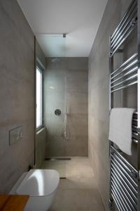 a bathroom with a shower with a toilet and a sink at Kalypso Residence in Methoni