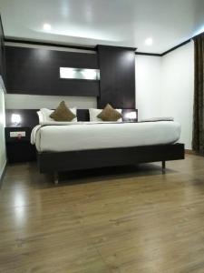a bedroom with a large bed in a room at saravanaa residency in Madurai