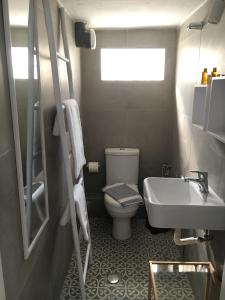 a small bathroom with a toilet and a sink at Aristotelia Gi - Panorama in Olympiada