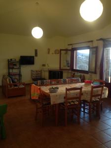 a living room with a wooden table and chairs at Lazy Farm in Prásinon