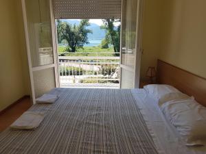 a bedroom with a bed and a large glass door at Albergo Meridiana in Pergine Valsugana
