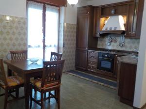 a kitchen with a table and a stove top oven at Casa Romme in Tornolo