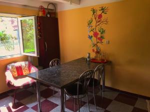 a dining room with a black table and chairs at DEA in Zugdidi