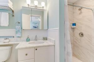 a white bathroom with a sink and a shower at Coral Cottage Retreat in Naples +19 photos
