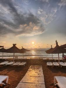 a beach with chairs and umbrellas and the ocean at SeaLover Apartment in Constanţa