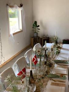 a long table with wine bottles and glasses on it at 7 Bedrooms Horse Farm near Skagen in Jerup