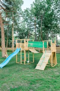 a wooden playground with a slide at The Peaceful Vacation- Villa M in Muratsi
