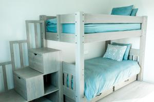 a white bunk bed with a night stand next to it at The Peaceful Vacation- Villa M in Muratsi