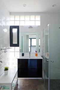 a bathroom with a sink and a shower and a mirror at Luxury Duplex, sea view 2min to beach parking in Tel Aviv