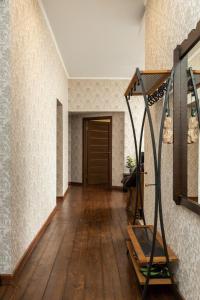 a hallway with a wooden floor and a door at Dagda Central apartment in Rīga